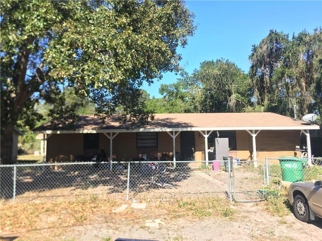 a view of a house with snow on the road