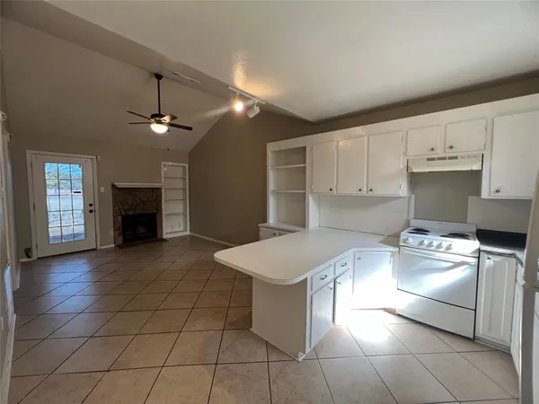 a kitchen with a cabinets and appliances