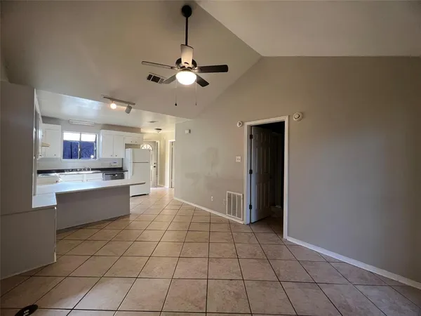 a large kitchen with a refrigerator a sink dishwasher and a stove