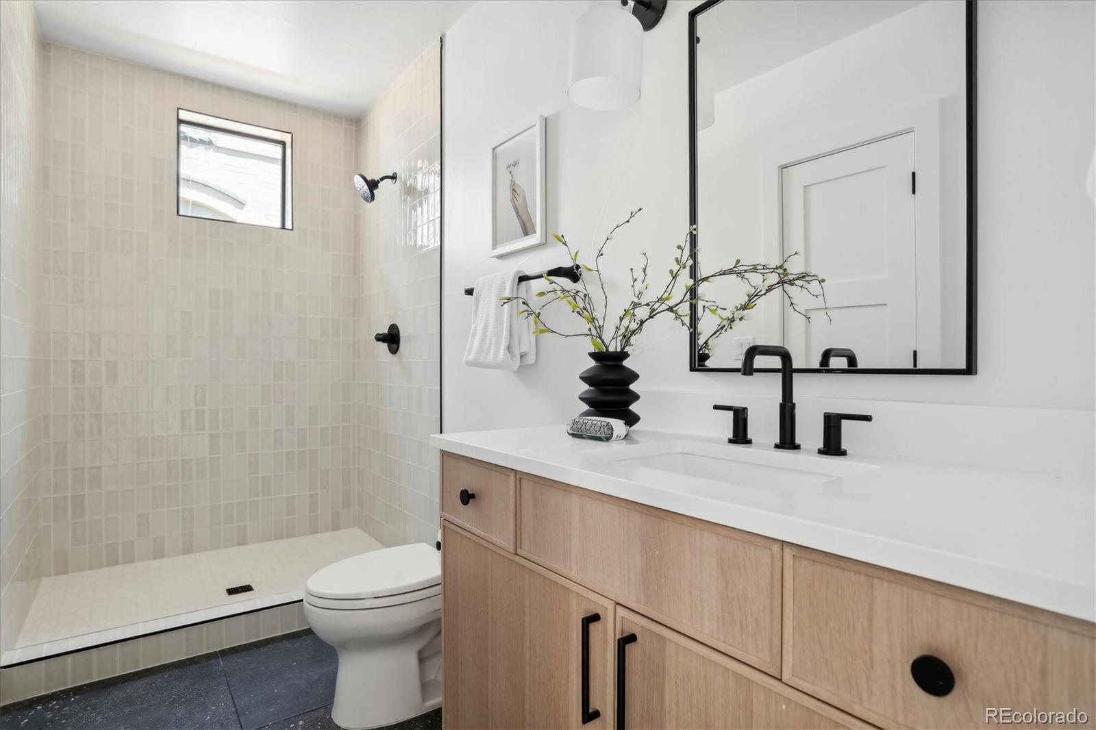 2228 Lowell Boulevard Denver, CO 80211 - Photo 11 of 49 a bathroom with a sink a toilet and shower