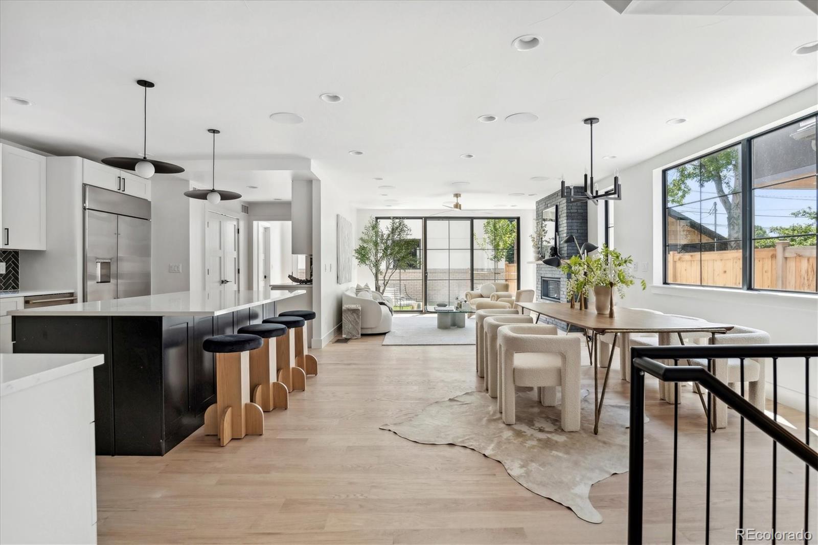 2228 Lowell Boulevard Denver, CO 80211 - Photo 12 of 49 a living room with lots of furniture and kitchen view