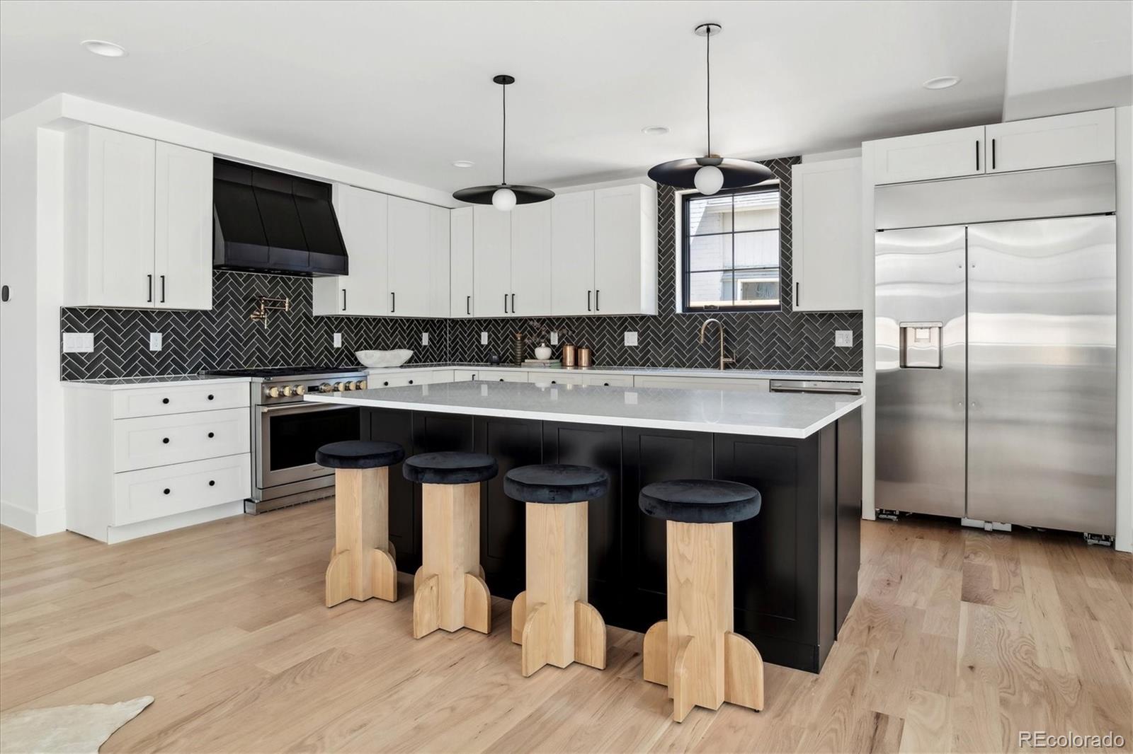 2228 Lowell Boulevard Denver, CO 80211 - Photo 14 of 49 a kitchen with a sink a counter space and stainless steel appliances