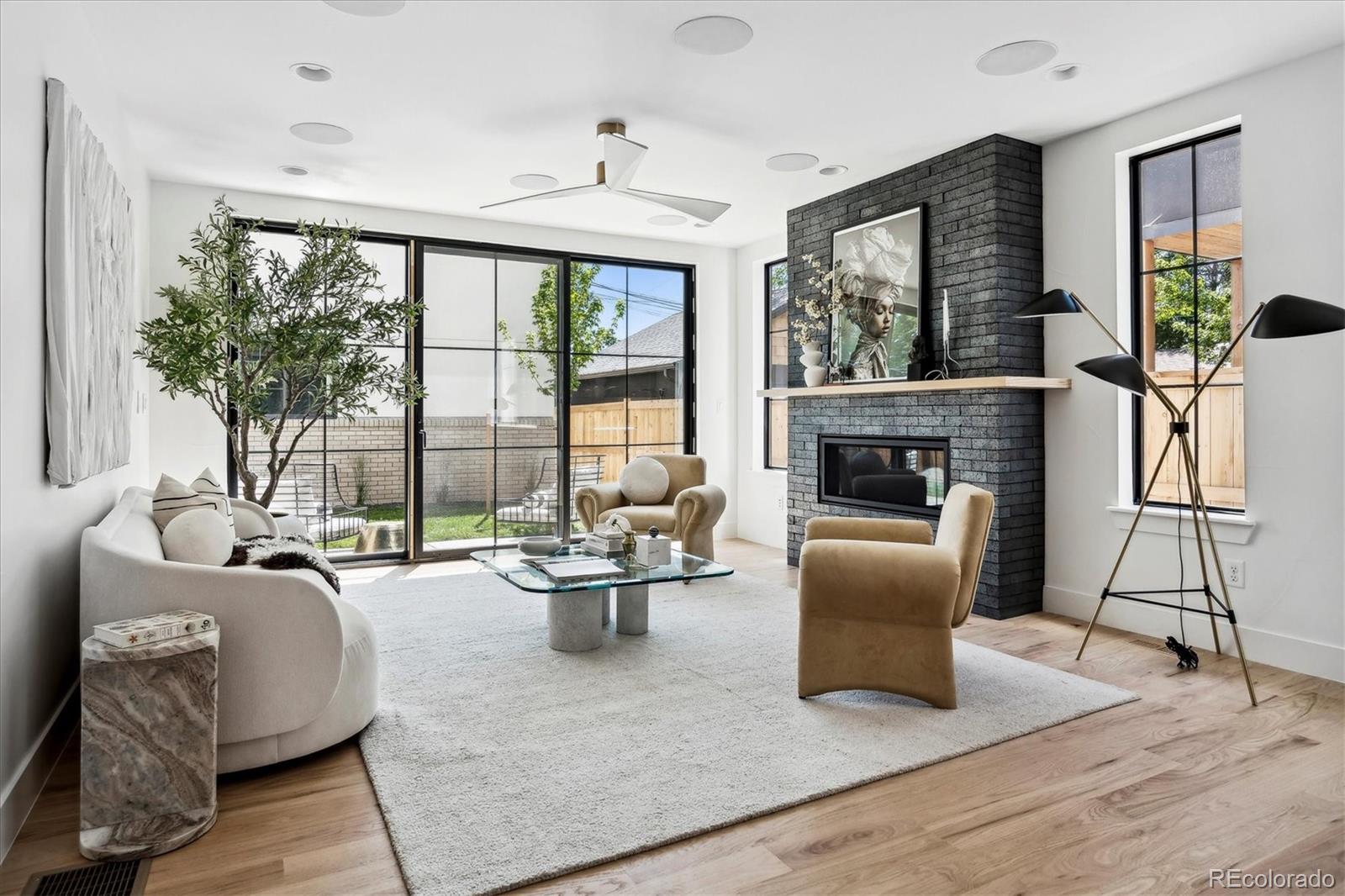 2228 Lowell Boulevard Denver, CO 80211 - Photo 18 of 49 a living room with furniture large windows and a fireplace