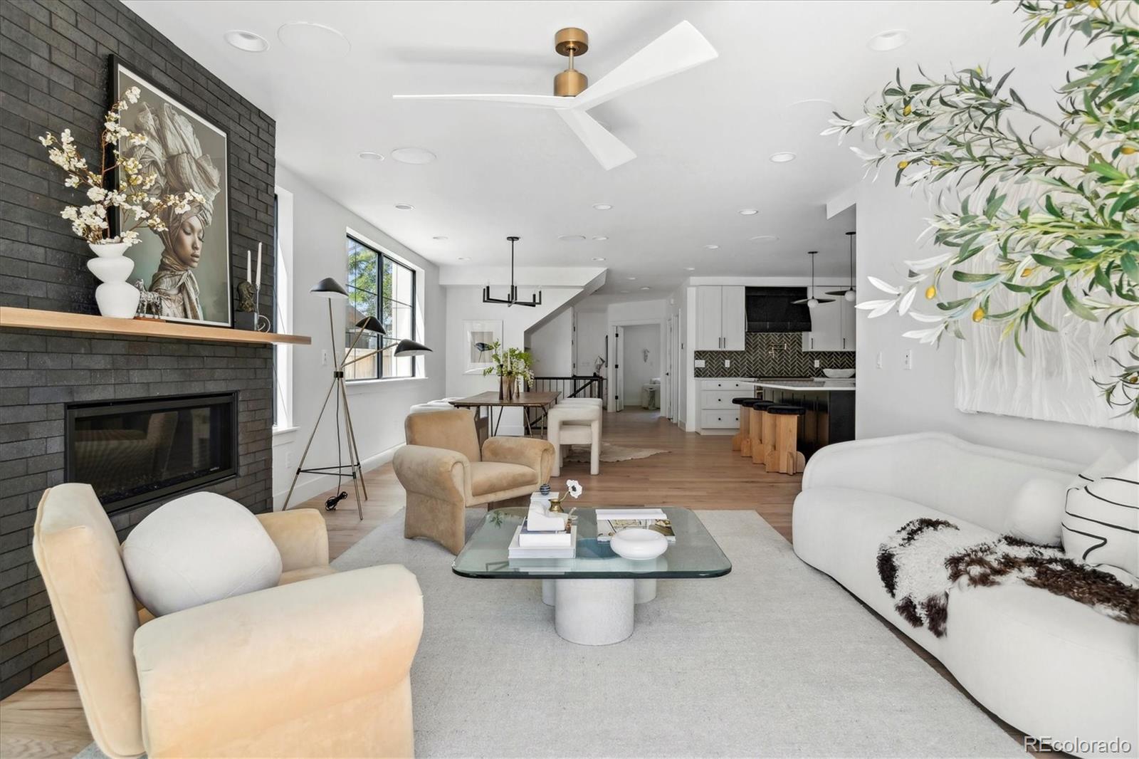 2228 Lowell Boulevard Denver, CO 80211 - Photo 19 of 49 a living room with furniture a flat screen tv and a fireplace