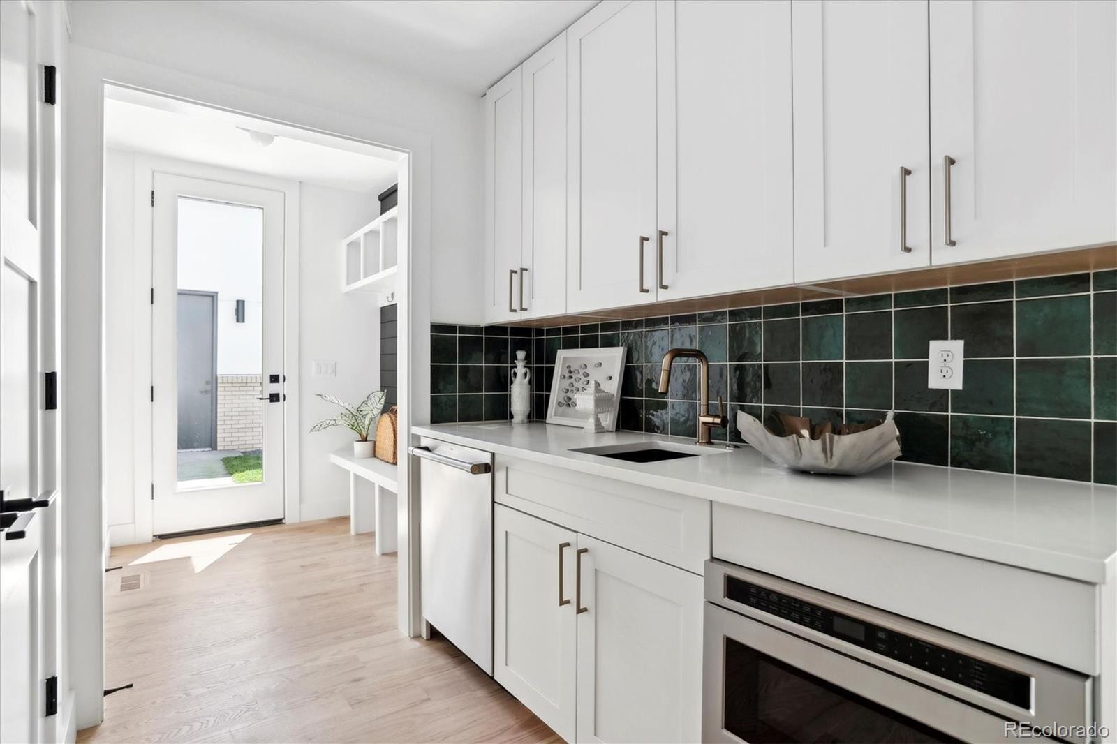 2228 Lowell Boulevard Denver, CO 80211 - Photo 20 of 49 a kitchen with cabinets and appliances
