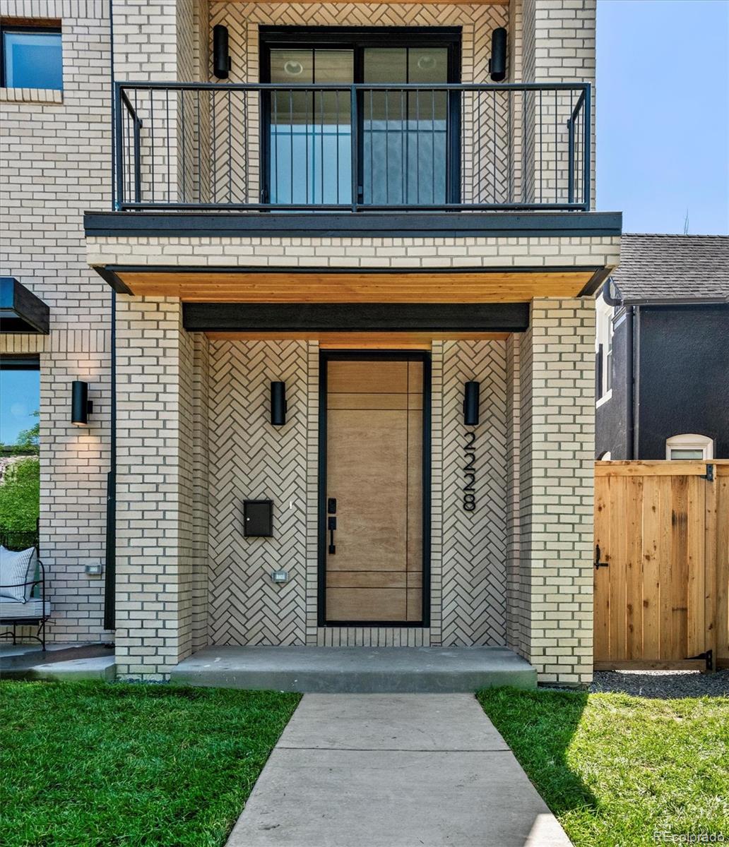 2228 Lowell Boulevard Denver, CO 80211 - Photo 2 of 49 a front view of a house with a garden