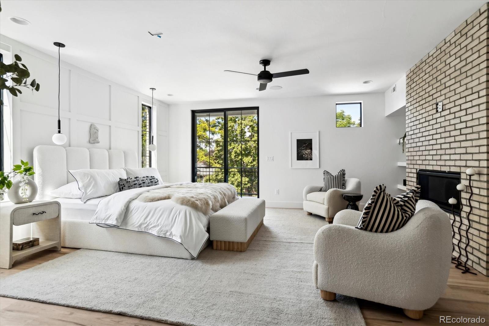 2228 Lowell Boulevard Denver, CO 80211 - Photo 23 of 49 a spacious bedroom with a bed a couch and a couch