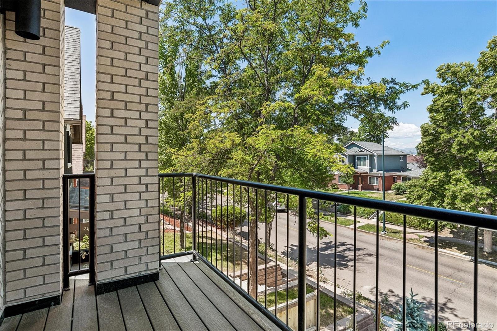 2228 Lowell Boulevard Denver, CO 80211 - Photo 26 of 49 a view of balcony with wooden floor and fence