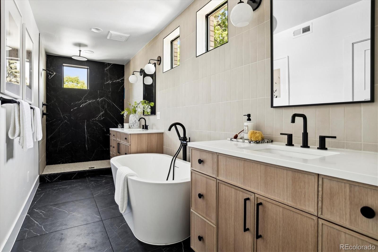 2228 Lowell Boulevard Denver, CO 80211 - Photo 27 of 49 a bathroom with a bathtub sink and mirror