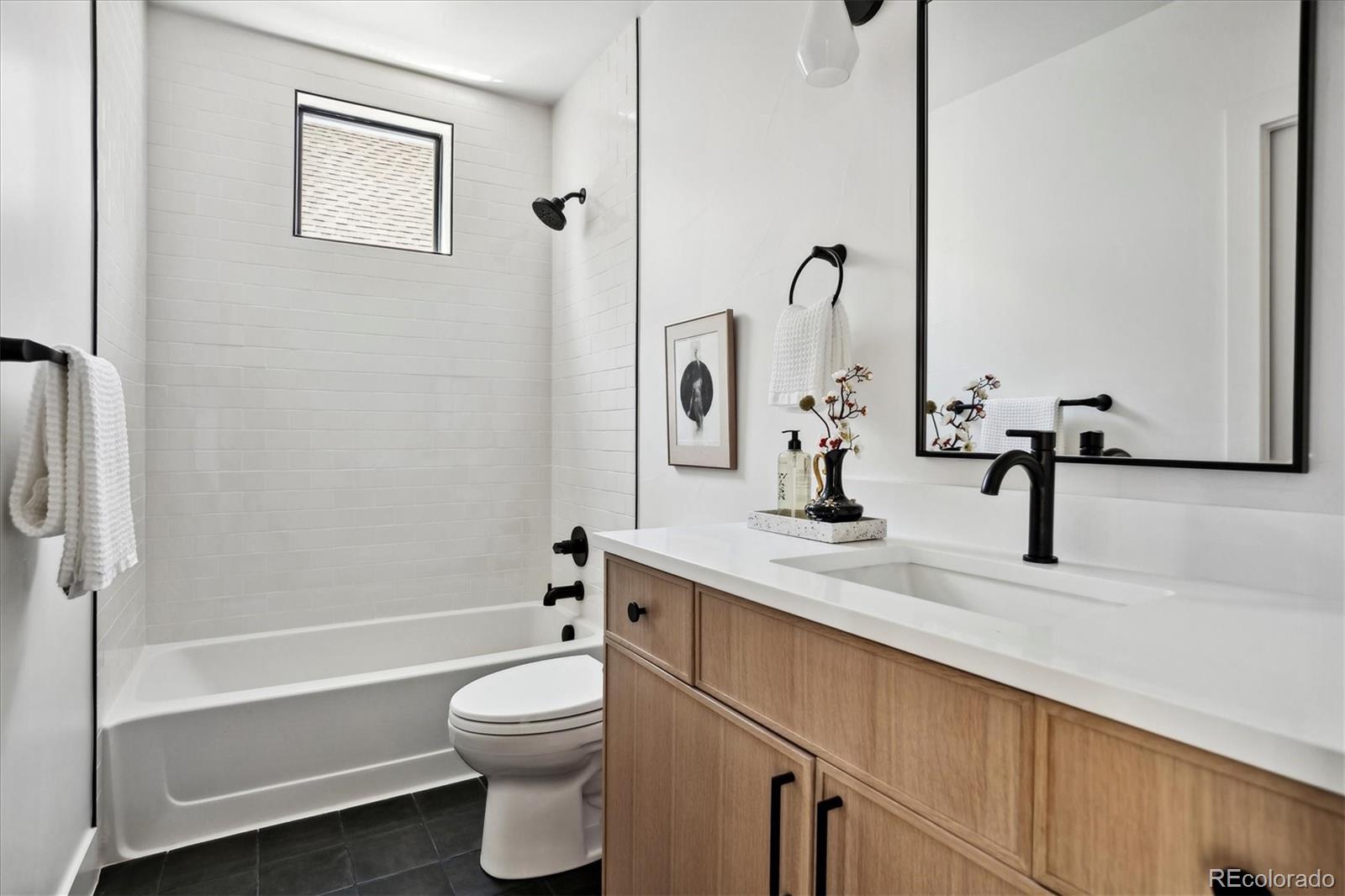 2228 Lowell Boulevard Denver, CO 80211 - Photo 31 of 49 a bathroom with a sink a toilet and a bathtub