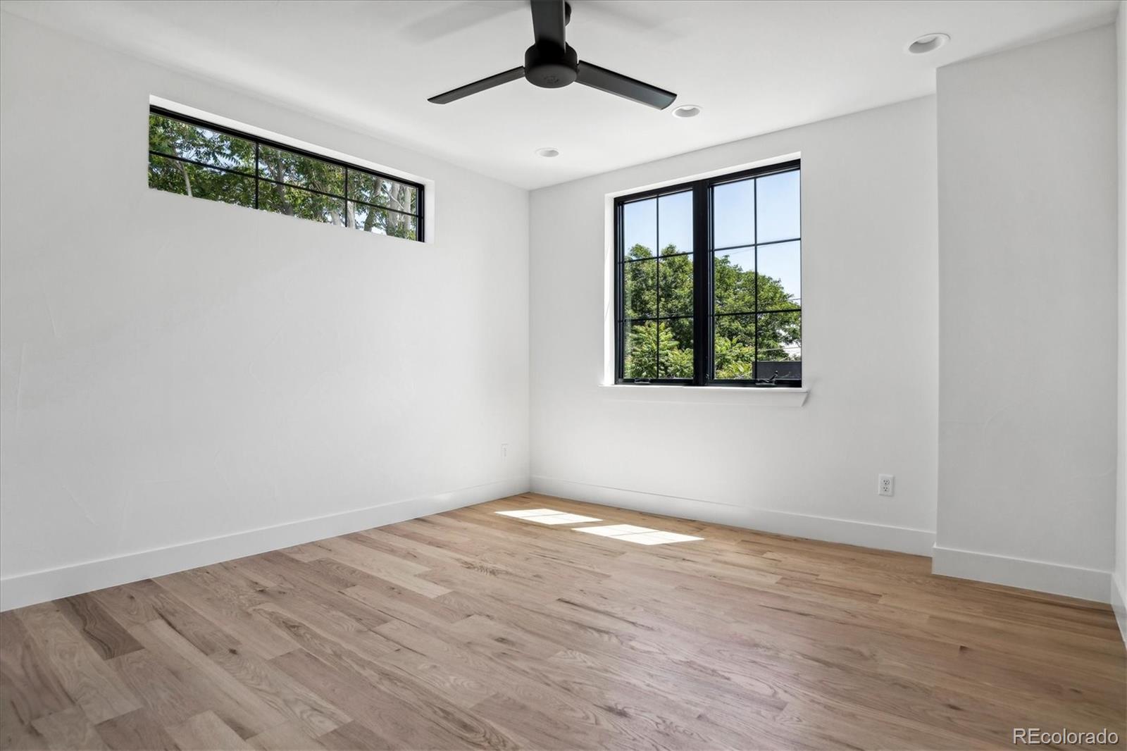 2228 Lowell Boulevard Denver, CO 80211 - Photo 32 of 49 a view of a room with wooden floor and a window