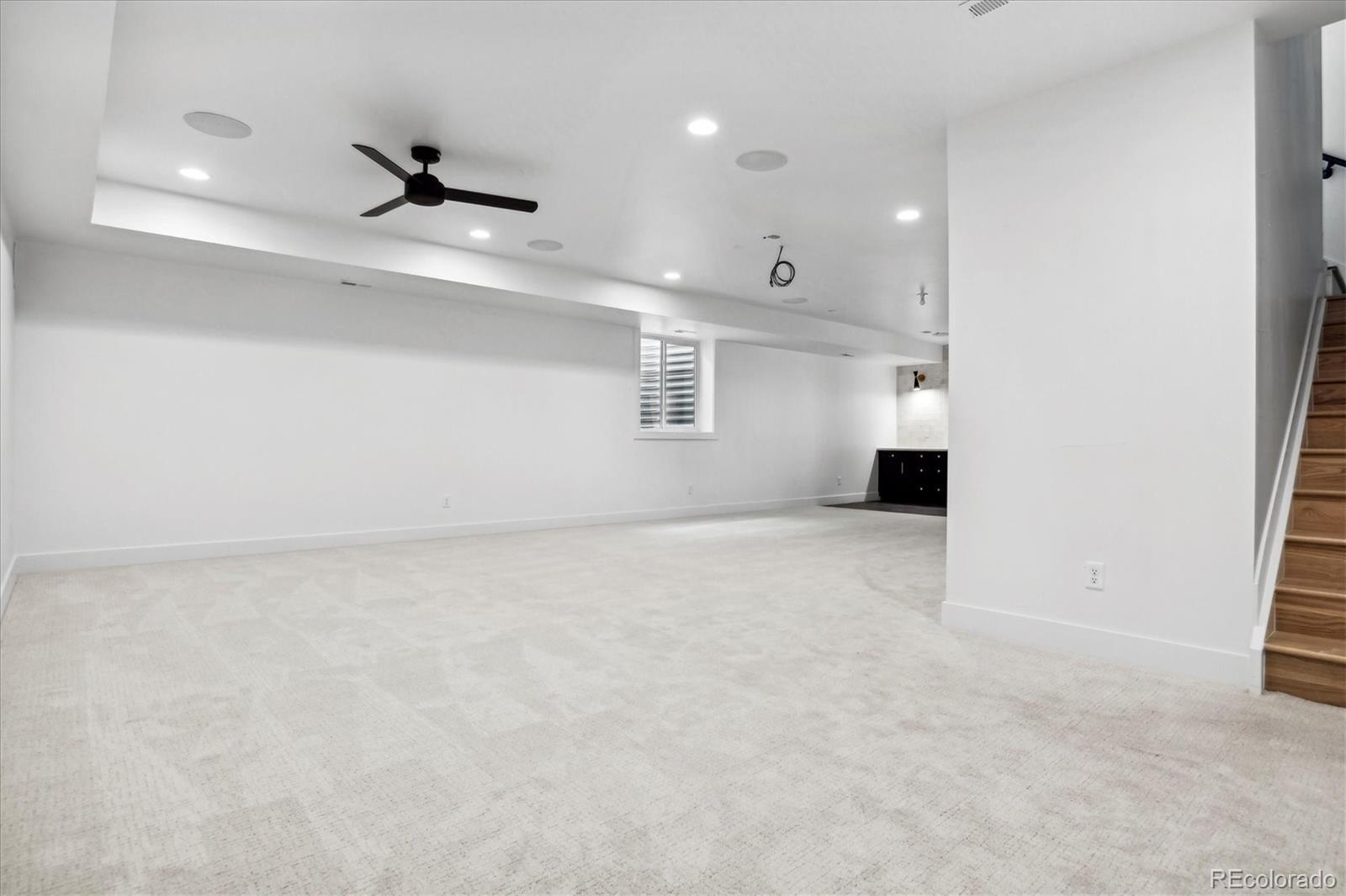 2228 Lowell Boulevard Denver, CO 80211 - Photo 41 of 49 an empty room with a ceiling fan and natural light