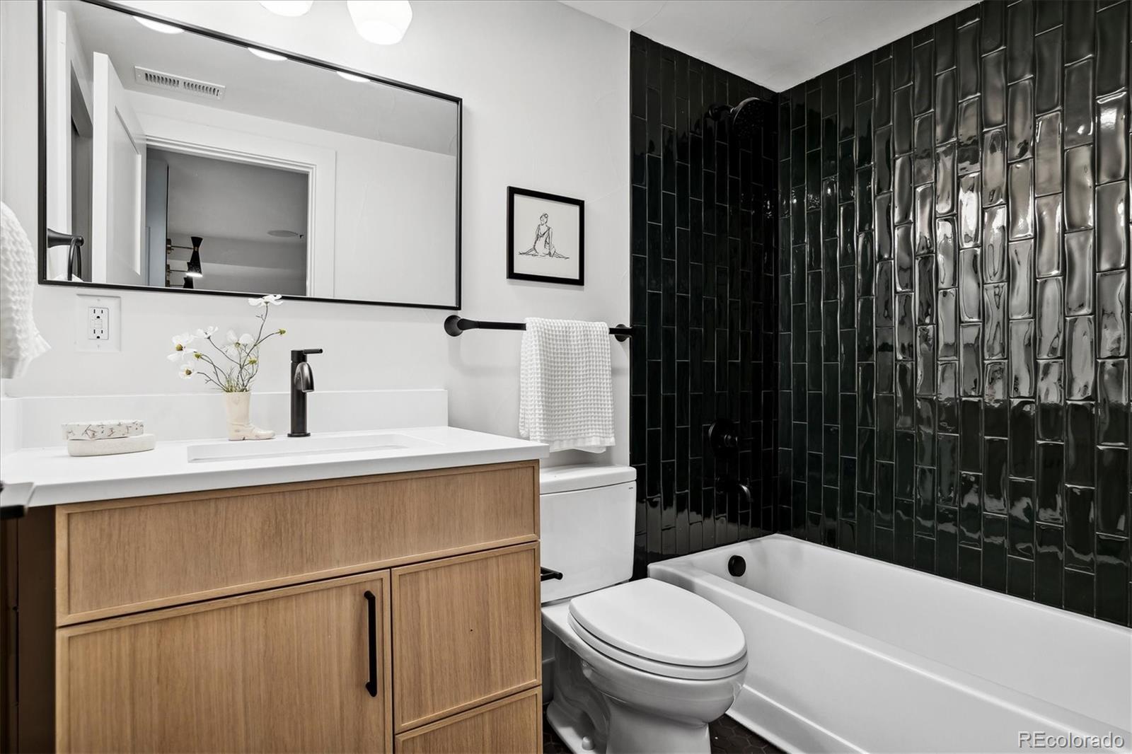 2228 Lowell Boulevard Denver, CO 80211 - Photo 43 of 49 a bathroom with a sink toilet vanity and shower