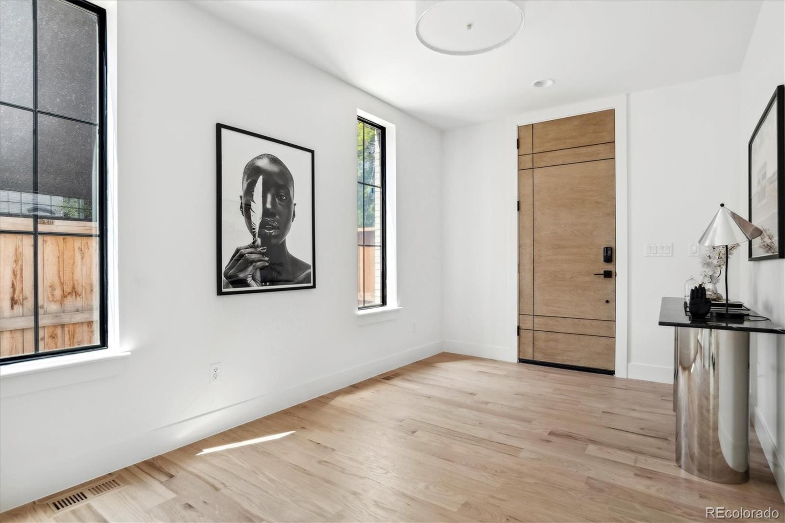 2228 Lowell Boulevard Denver, CO 80211 - Photo 7 of 49 a view of a hallway with wooden floor and closet