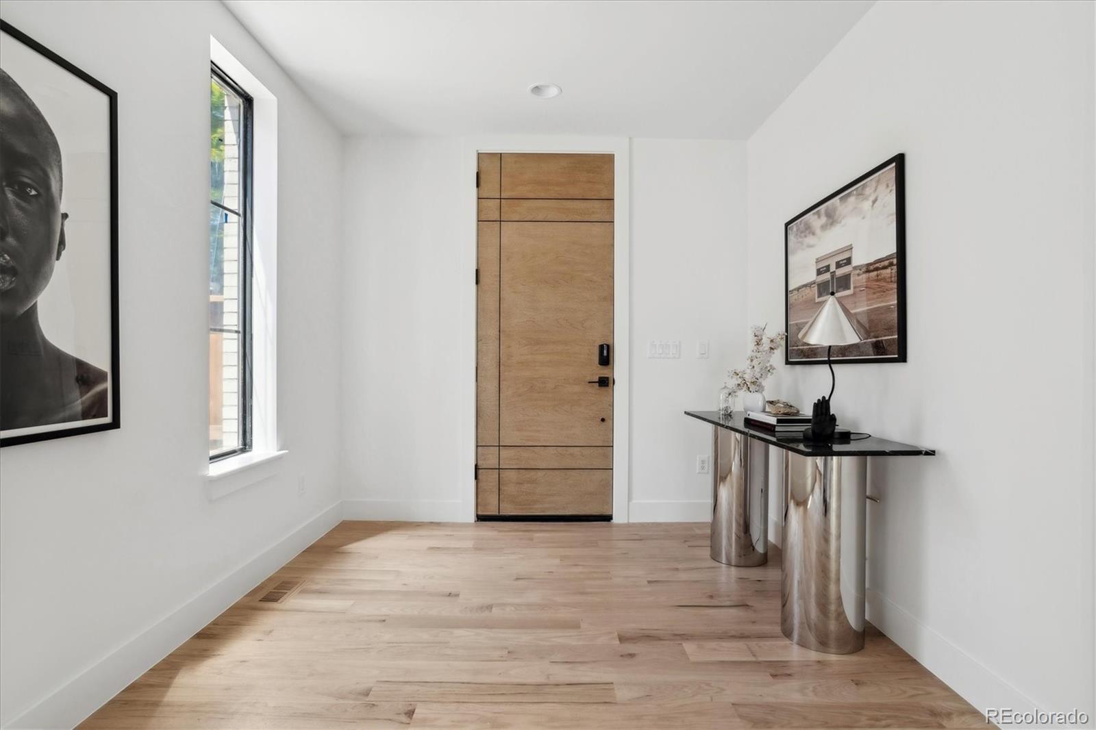 2228 Lowell Boulevard Denver, CO 80211 - Photo 8 of 49 a view of a hallway with a window and wooden floor