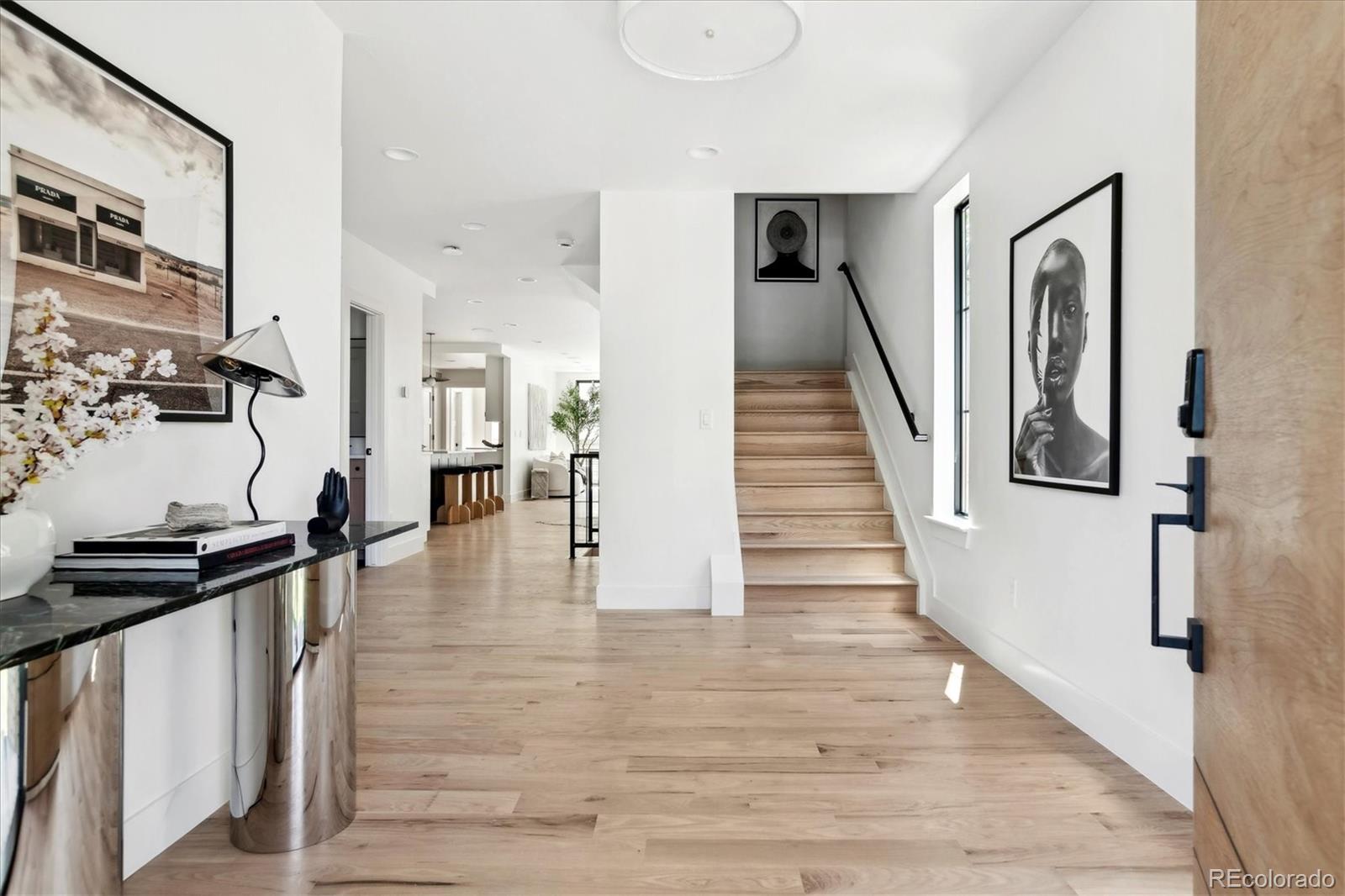 2228 Lowell Boulevard Denver, CO 80211 - Photo 9 of 49 a view of a hallway with wooden floor and staircase