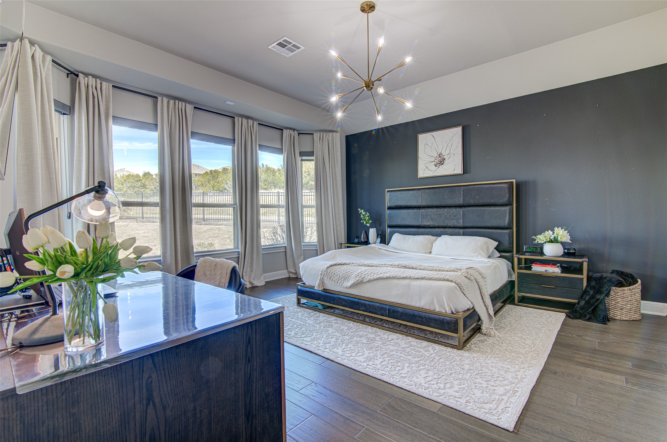 4309 Olive Grv Cove Leander, TX 78641 - Photo 16 of 27 Bedroom featuring wood-type flooring and a chandelier