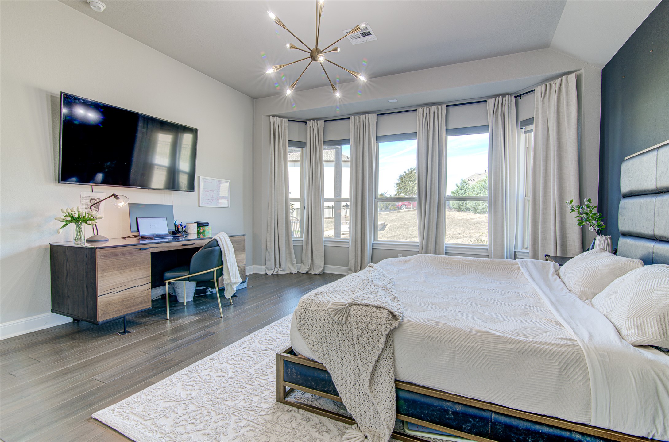 4309 Olive Grv Cove Leander, TX 78641 - Photo 17 of 27 Bedroom featuring hanging lights, wood finished floors, an office area, and vaulted ceiling