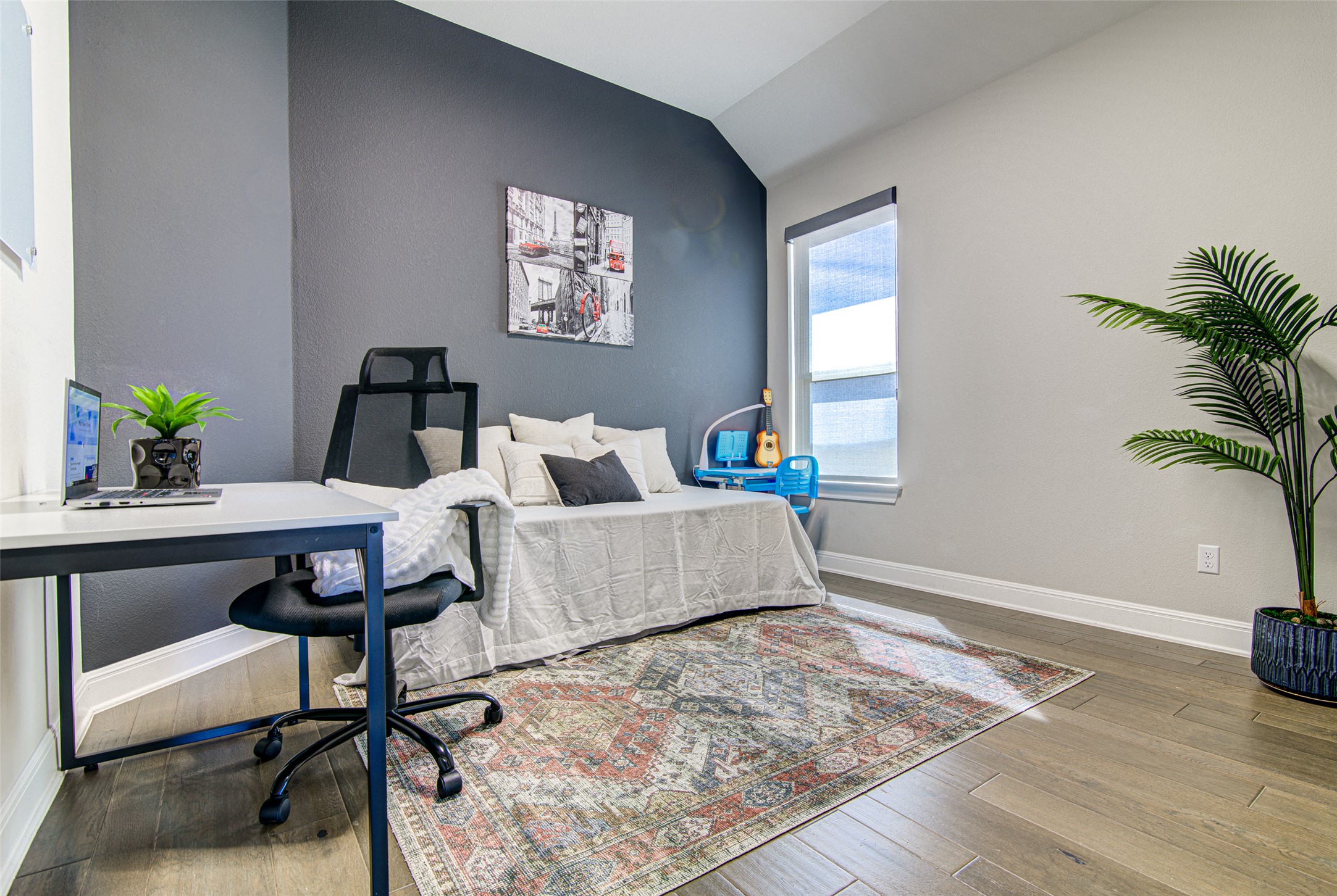 4309 Olive Grv Cove Leander, TX 78641 - Photo 20 of 27 Bedroom featuring lofted ceiling, a desk, and light wood finished floors
