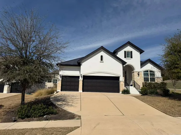 a front view of a house with yard and garage