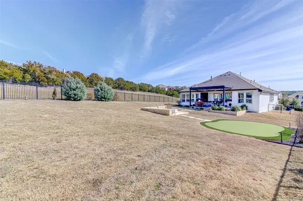 a swimming pool with outdoor seating and yard