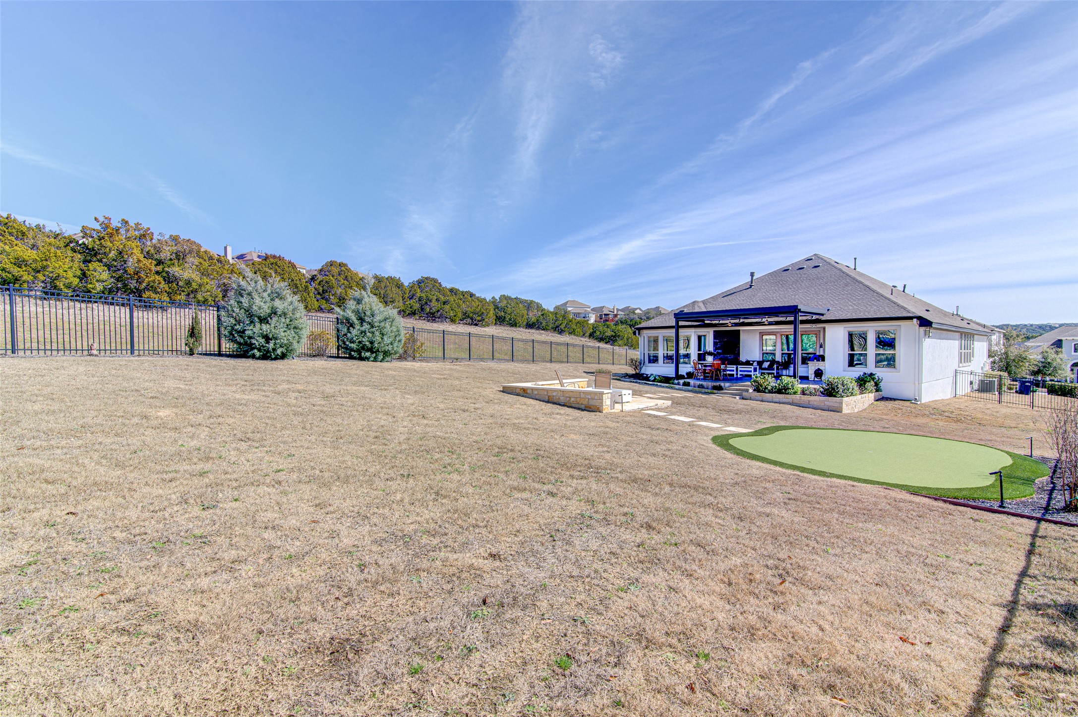 4309 Olive Grv Cove Leander, TX 78641 - Photo 22 of 27 Fenced backyard with a patio area and a putting green