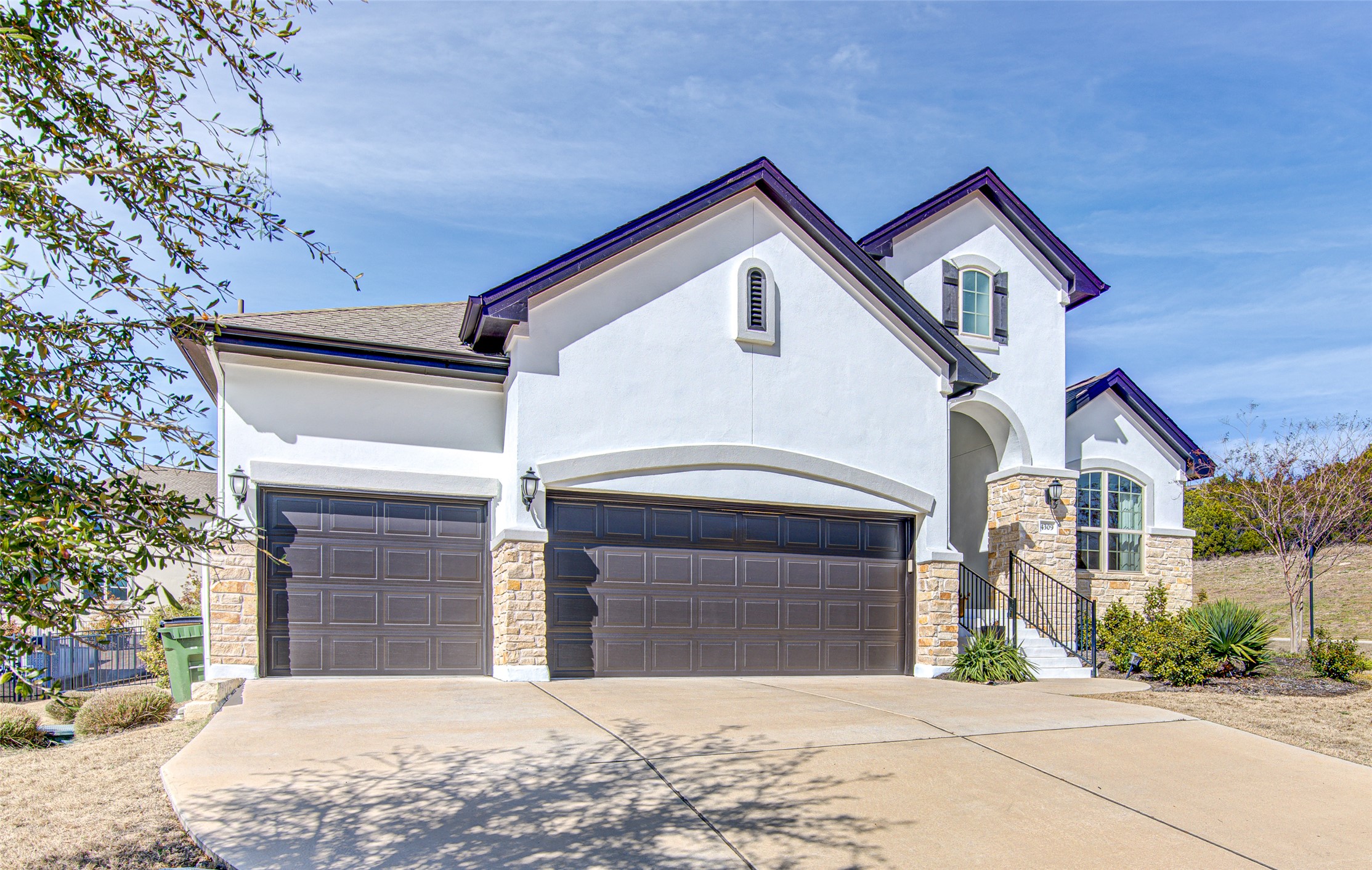 4309 Olive Grv Cove Leander, TX 78641 - Photo 5 of 27 View of front of property with stone siding, concrete driveway, stucco siding, and a garage