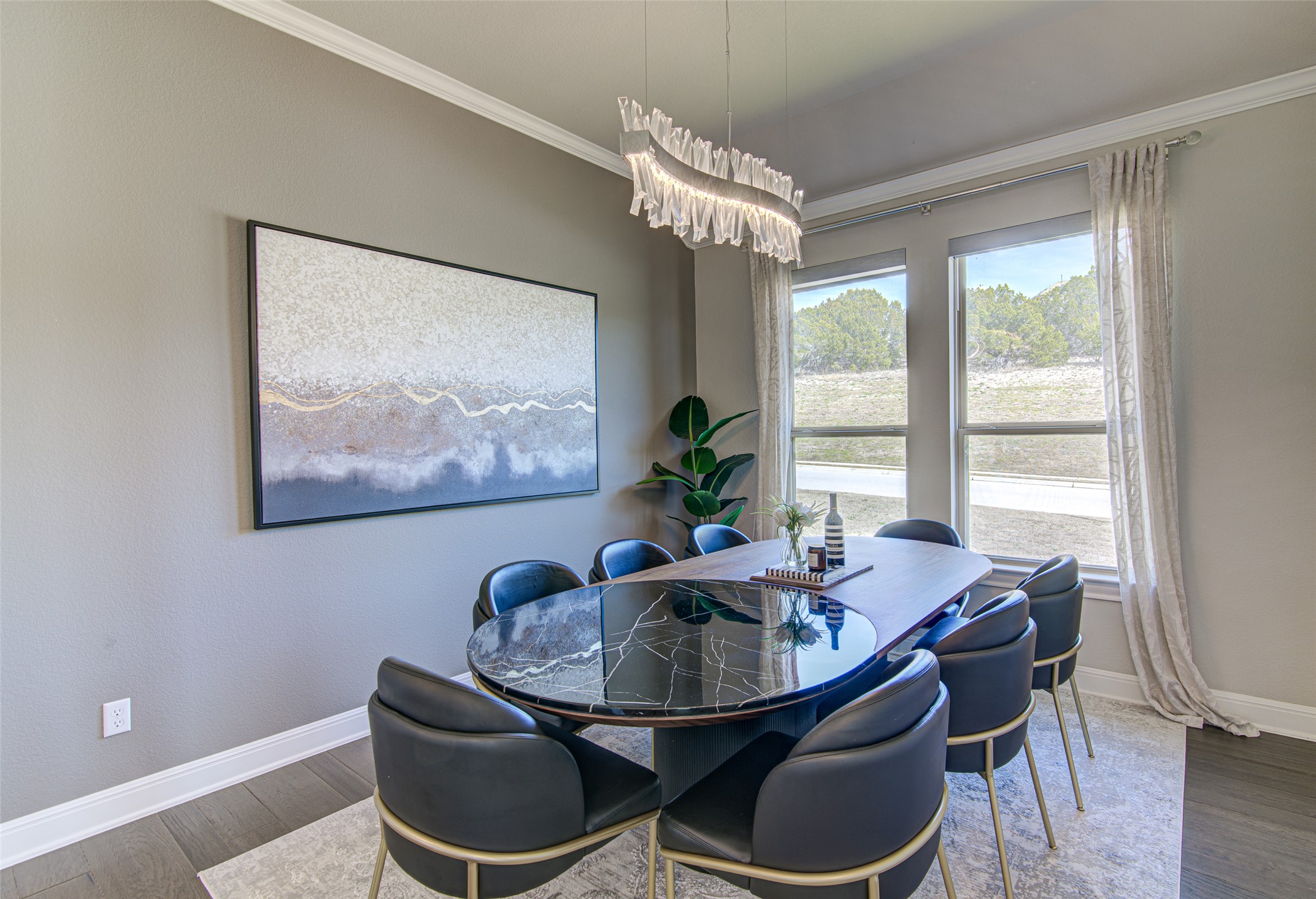 4309 Olive Grv Cove Leander, TX 78641 - Photo 8 of 27 Dining room with crown molding, wood finished floors, and suspended lighting