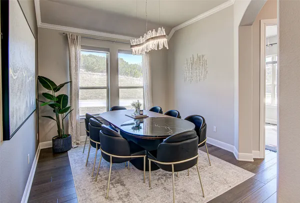 a dining room with furniture and wooden floor