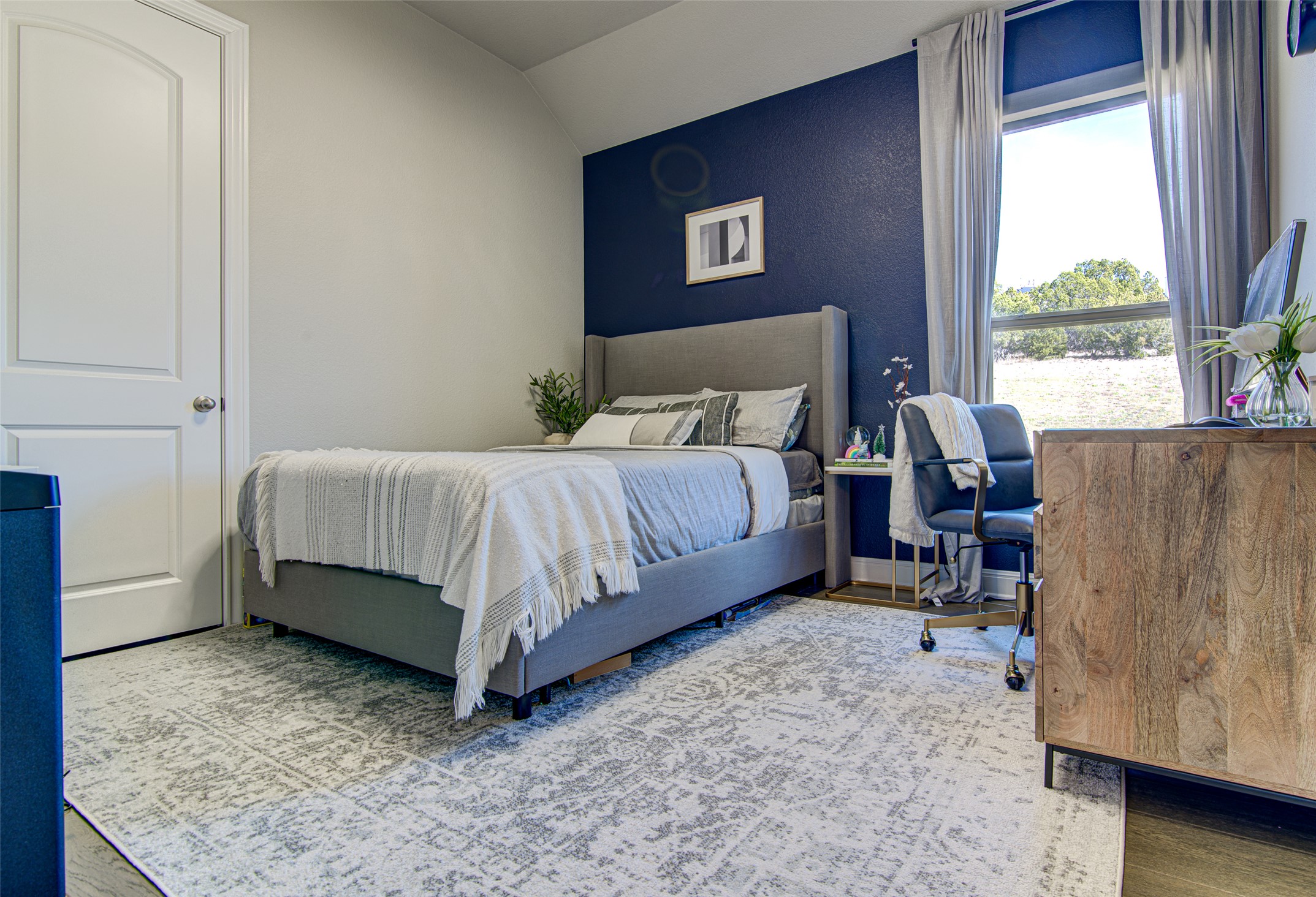 4309 Olive Grv Cove Leander, TX 78641 - Photo 10 of 27 Bedroom with wood finished floors and lofted ceiling