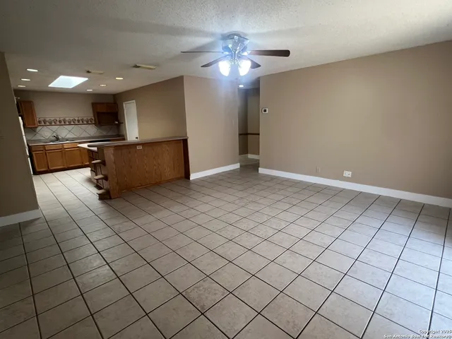 a kitchen with stainless steel appliances kitchen island granite countertop a refrigerator and a stove top oven