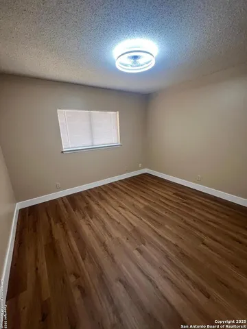 a view of room with window and hardwood floor