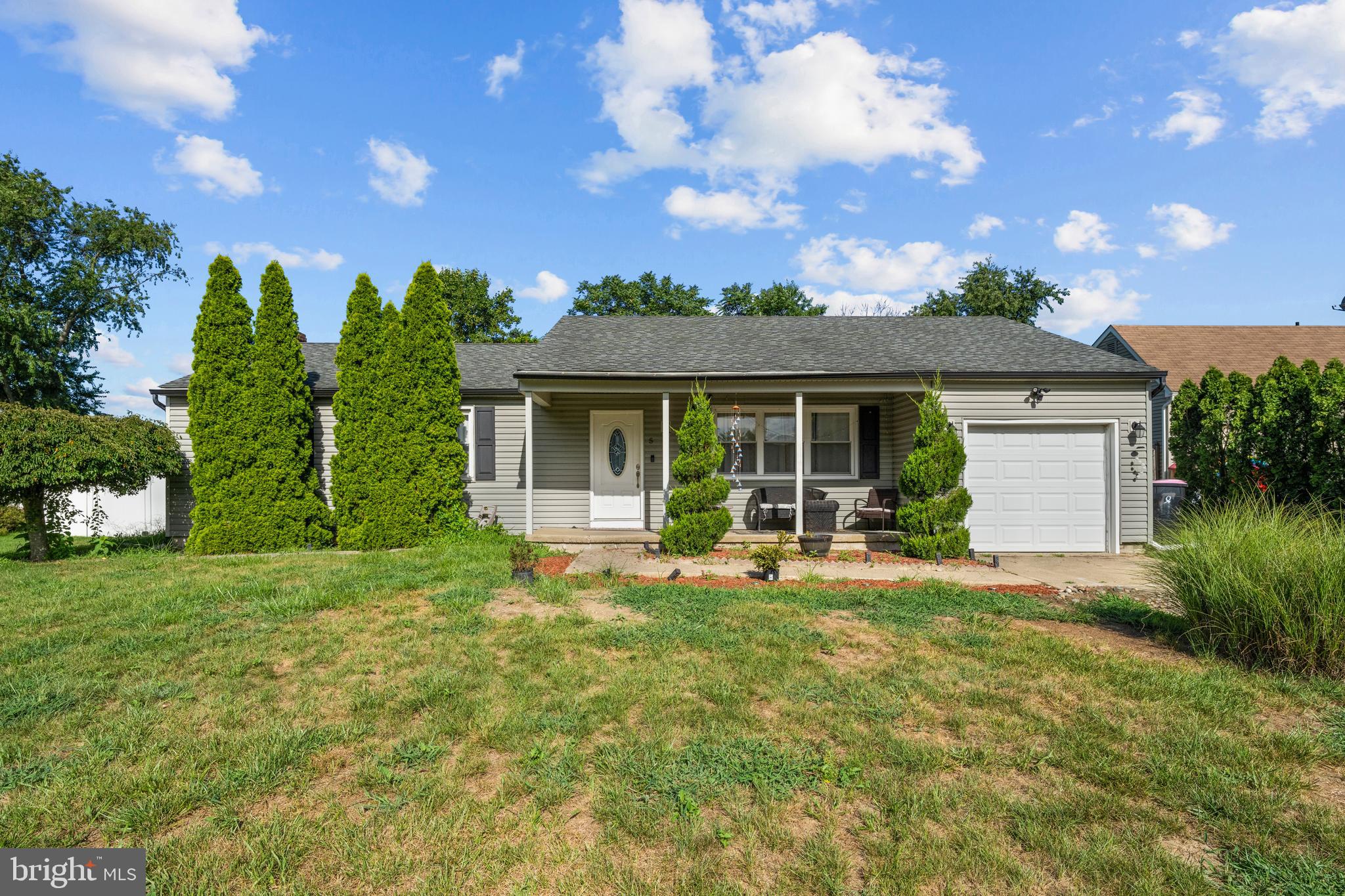 a front view of house with yard and green space