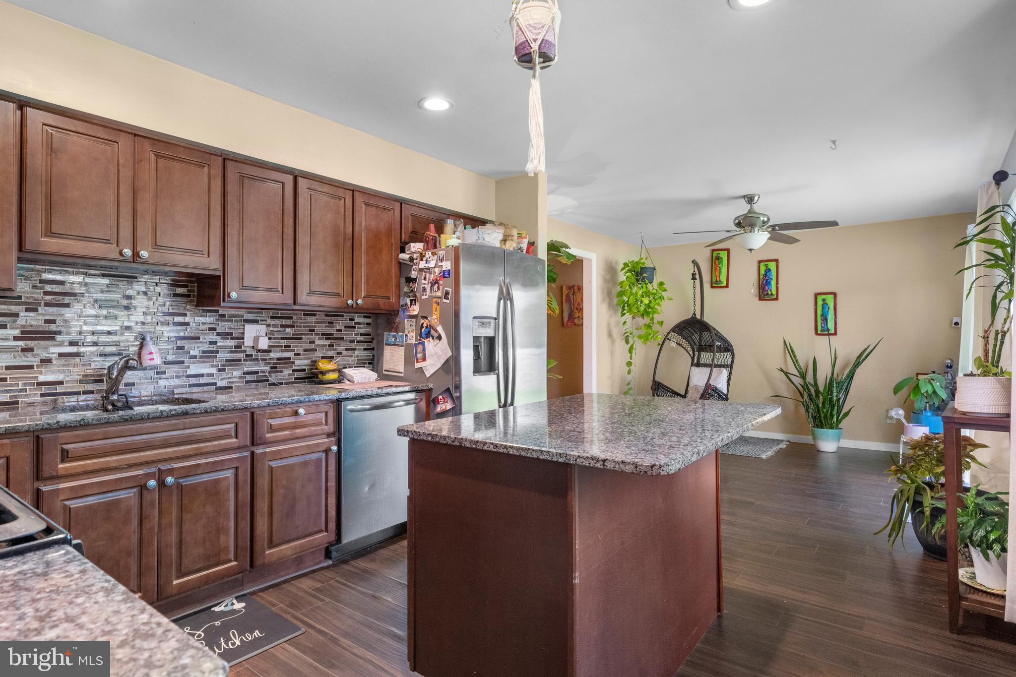 5 Fox Chase Drive Blackwood, NJ 08012 - Photo 13 of 23 a kitchen with stainless steel appliances kitchen island granite countertop a table and chairs in it