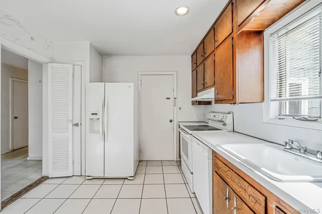 a kitchen with a sink a stove and refrigerator
