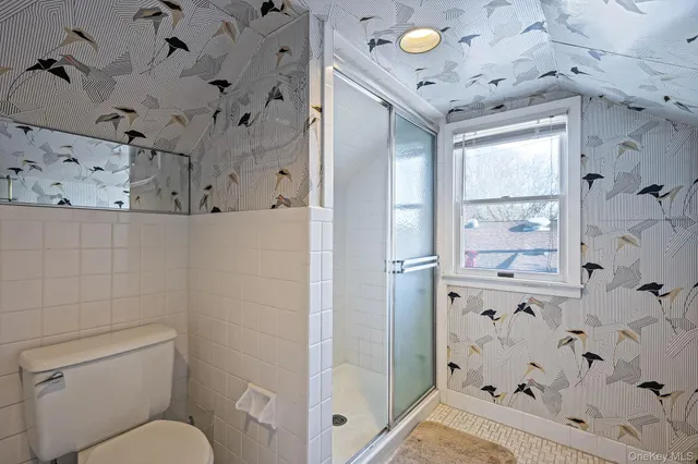 a bathroom with a toilet sink and shower