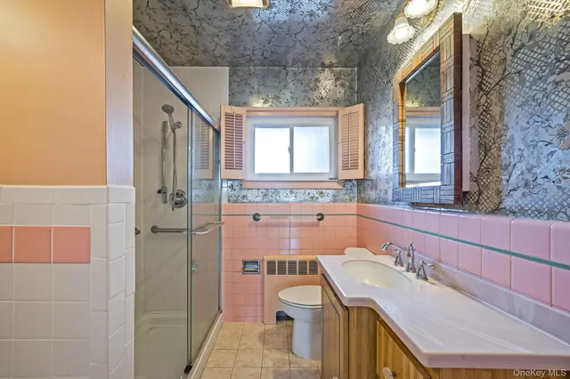 a bathroom with a sink a toilet and a mirror