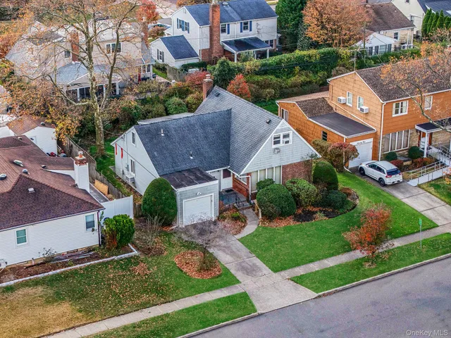an aerial view of multiple houses with a yard