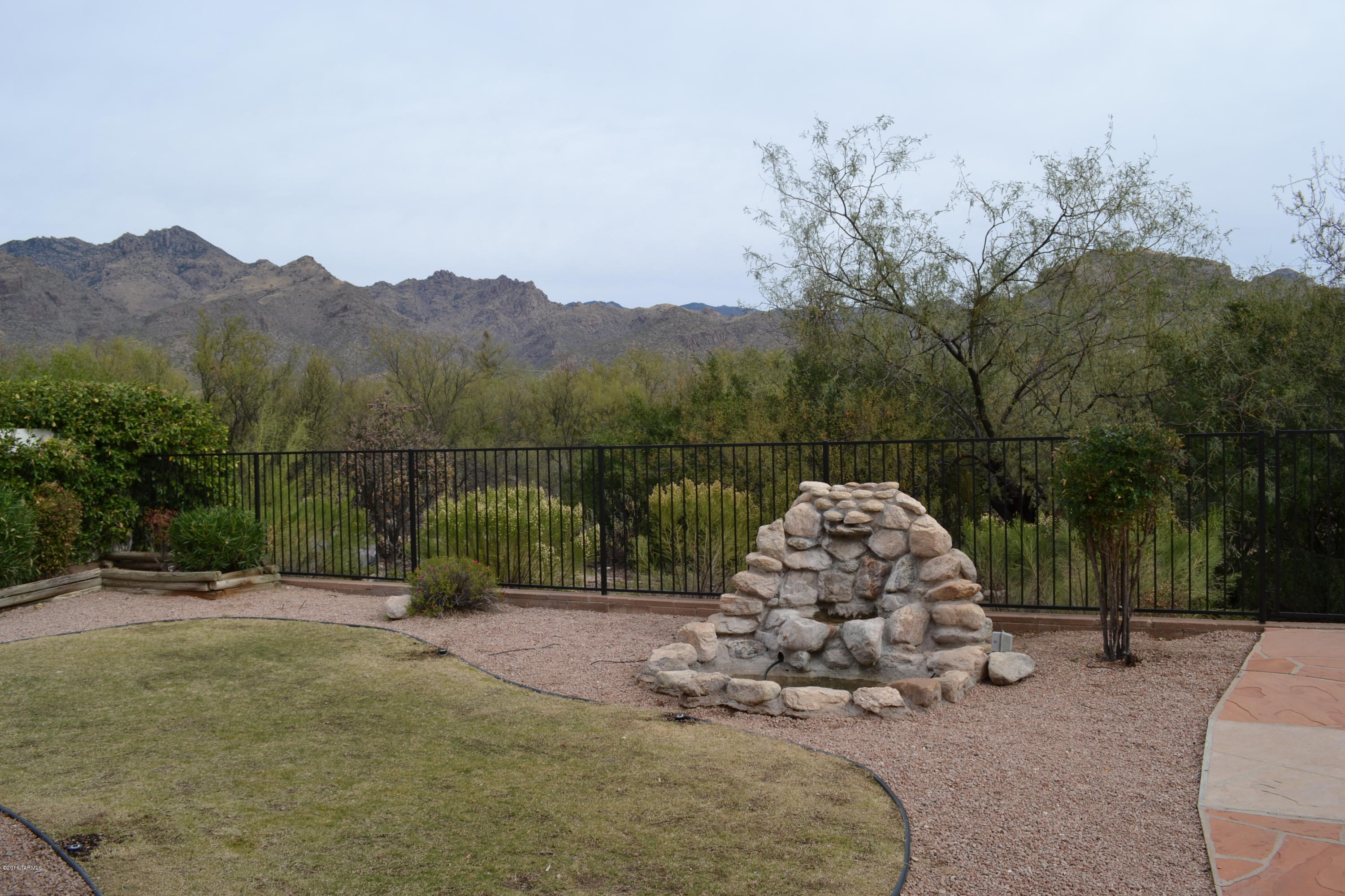 5640 North Cherokee Ridge Road Tucson, AZ 85750 - Photo 25 of 39 a view of a bench in front of a house
