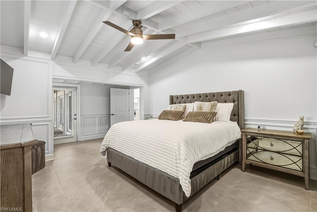 453 18th Avenue South Naples, FL 34102 - Photo 11 of 47 a bed room with a bed and a fireplace