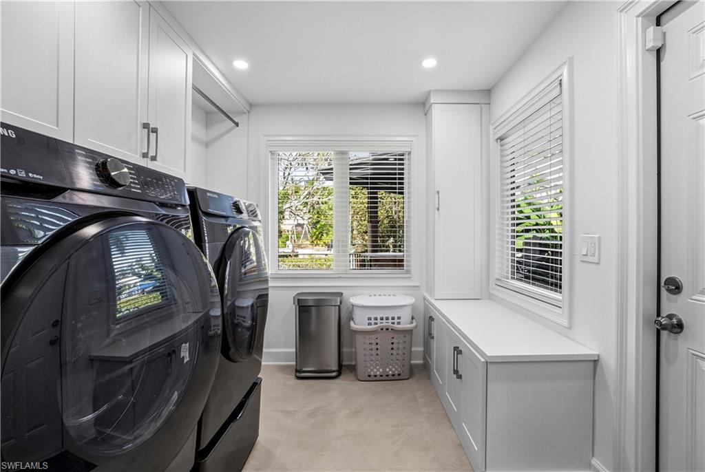 453 18th Avenue South Naples, FL 34102 - Photo 15 of 47 a bathroom with a sink a washer and dryer