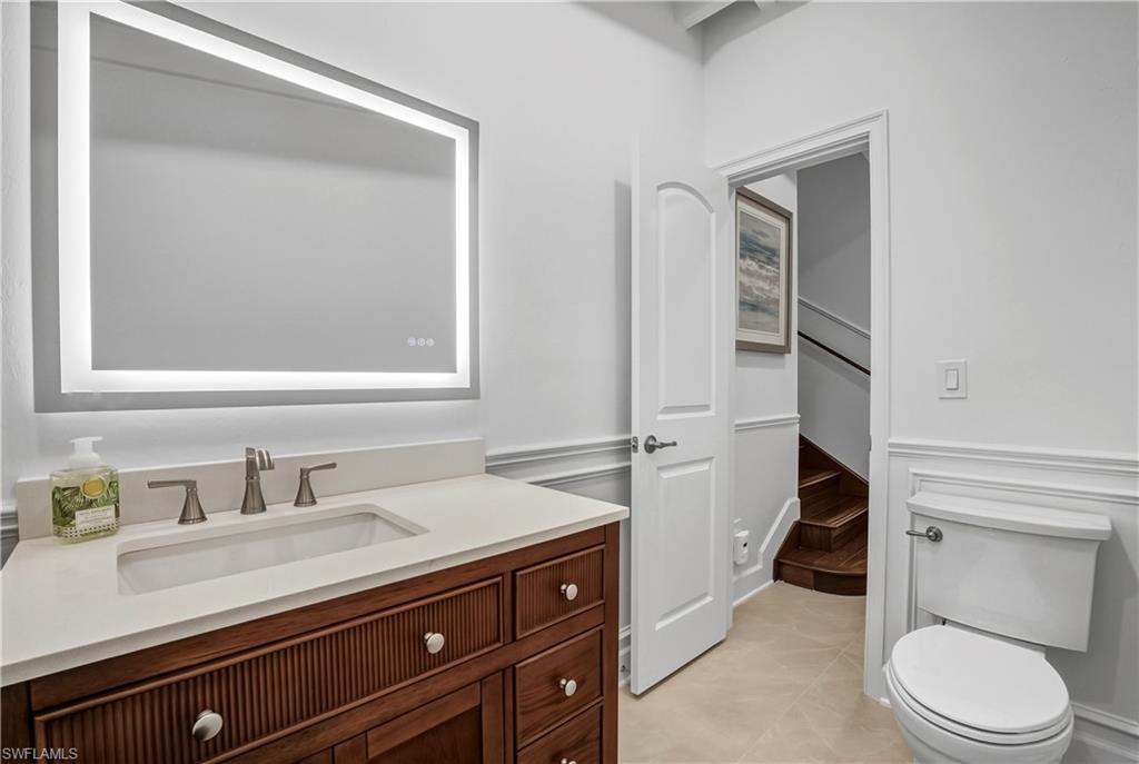 453 18th Avenue South Naples, FL 34102 - Photo 21 of 47 a bathroom with a toilet a sink and mirror