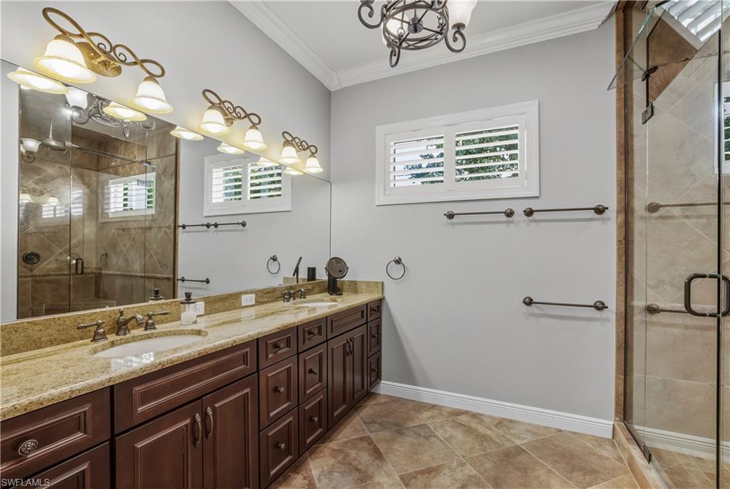 453 18th Avenue South Naples, FL 34102 - Photo 25 of 47 a bathroom with a granite countertop sink a large mirror and a shower