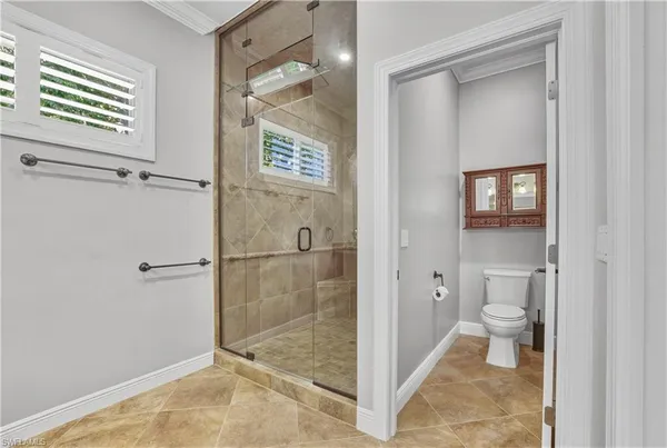 a bathroom with a toilet and a shower