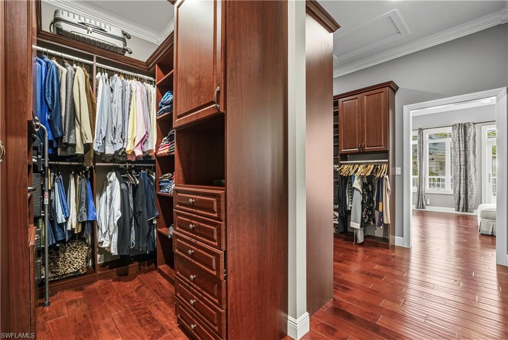453 18th Avenue South Naples, FL 34102 - Photo 28 of 47 a view of walk in closet with clothes and shoes