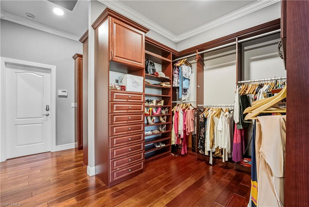 453 18th Avenue South Naples, FL 34102 - Photo 29 of 47 a view of walk in closet with clothes and shoes