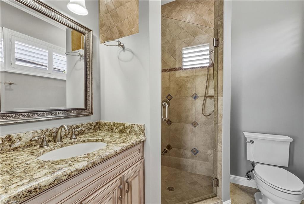 453 18th Avenue South Naples, FL 34102 - Photo 31 of 47 a bathroom with a granite countertop sink toilet and shower