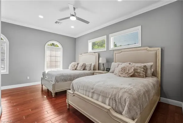 a bedroom with two beds and a window