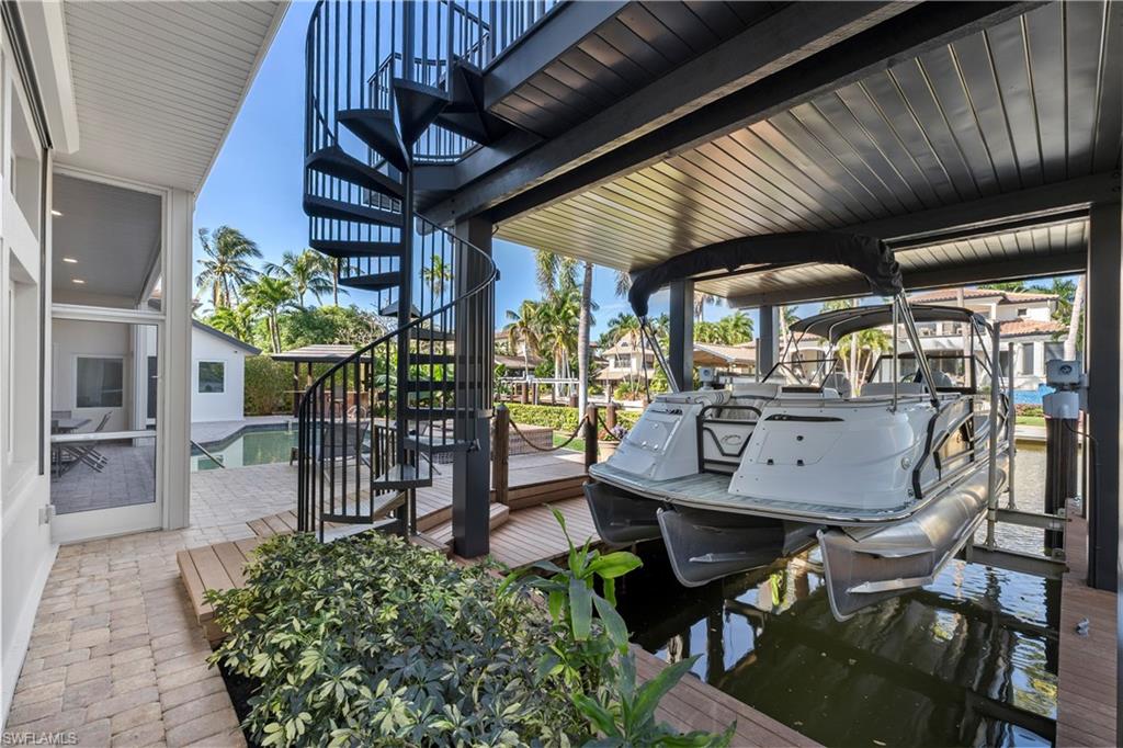 453 18th Avenue South Naples, FL 34102 - Photo 40 of 47 a view of a chairs and table in a patio