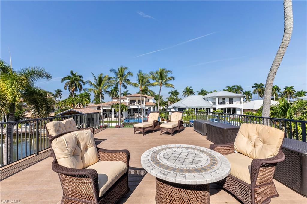 453 18th Avenue South Naples, FL 34102 - Photo 41 of 47 a balcony with table and chairs